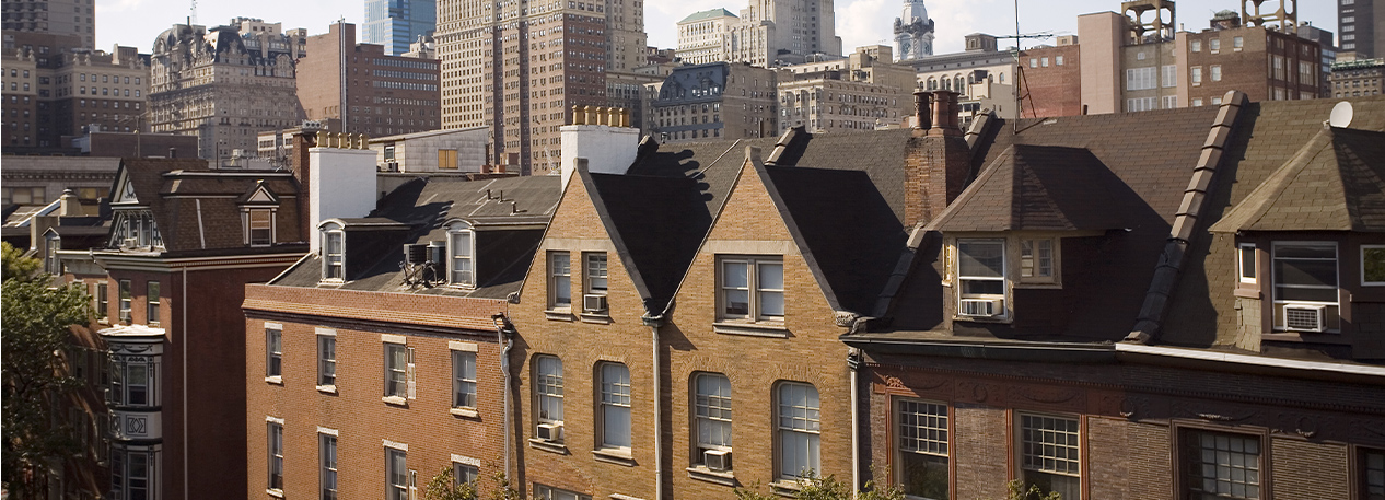 Row homes with the skyline of Philadelphia in the background.