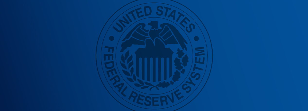 The seal of the United States Federal Reserve System in front of a blue background.