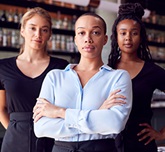 Three female restaurant workers face the camera.