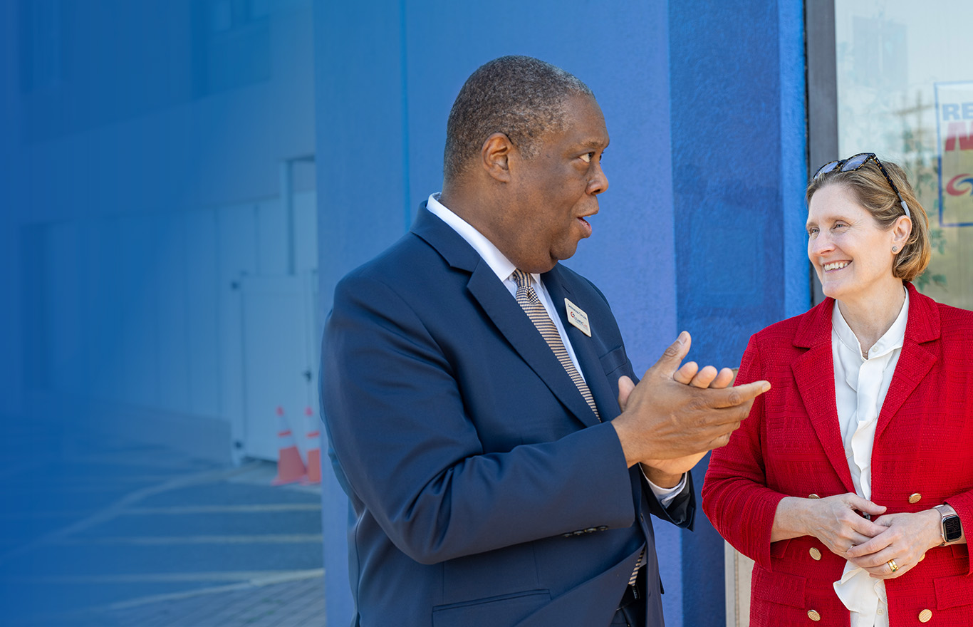 Anna Paulson conversing with a leader and observing a student