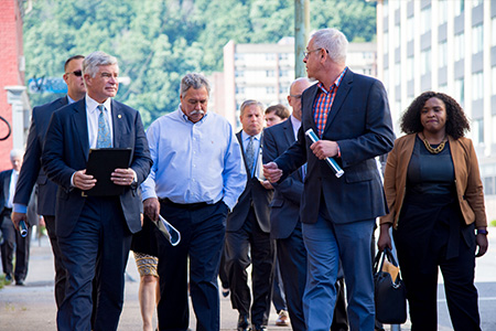 A group of people walking outside and talking