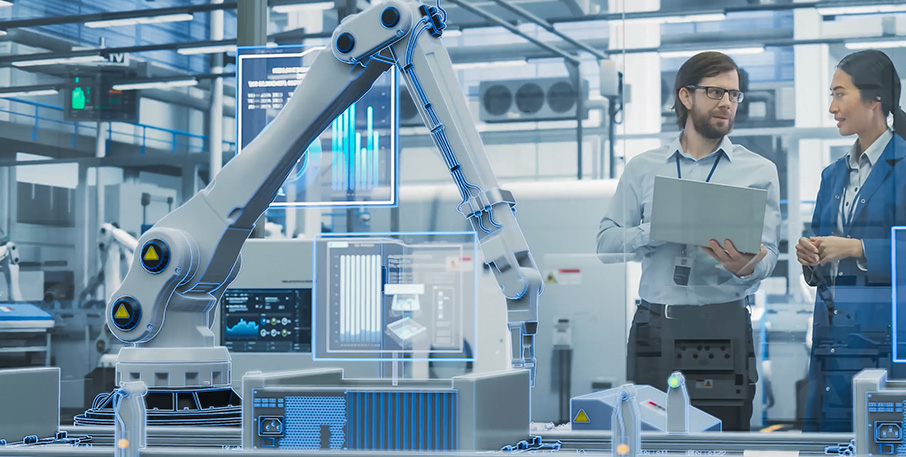 A man and woman work in a robotics lab.
