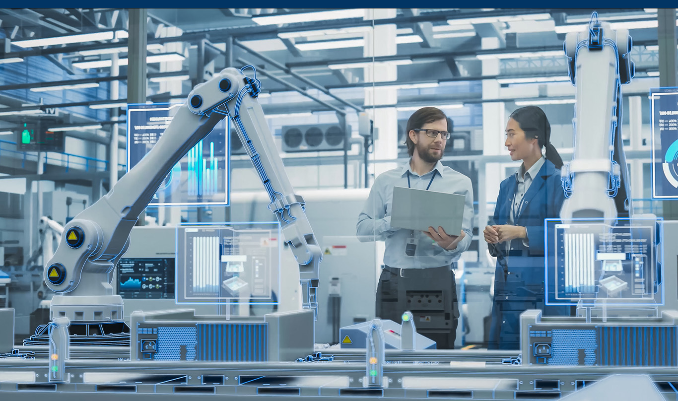 A man and woman work in a robotics lab.
