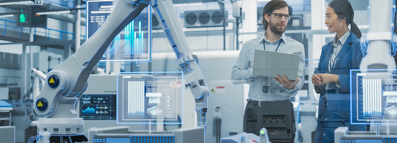 A man and woman work in a robotics lab.