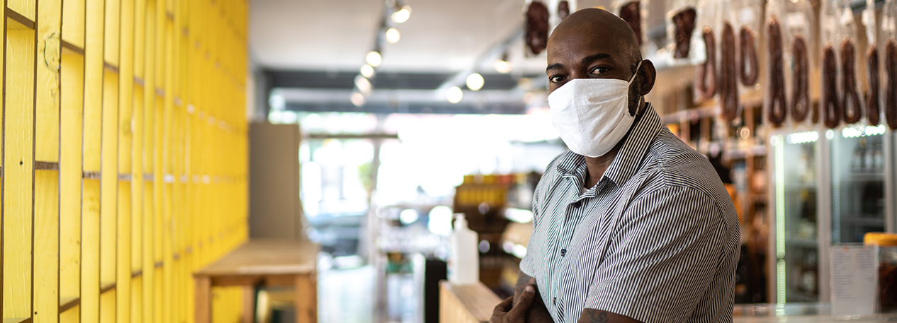 A business owner stands in his shop.