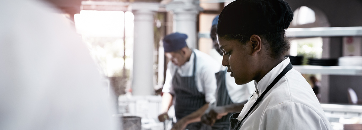 Chefs preparing food in a kitchen