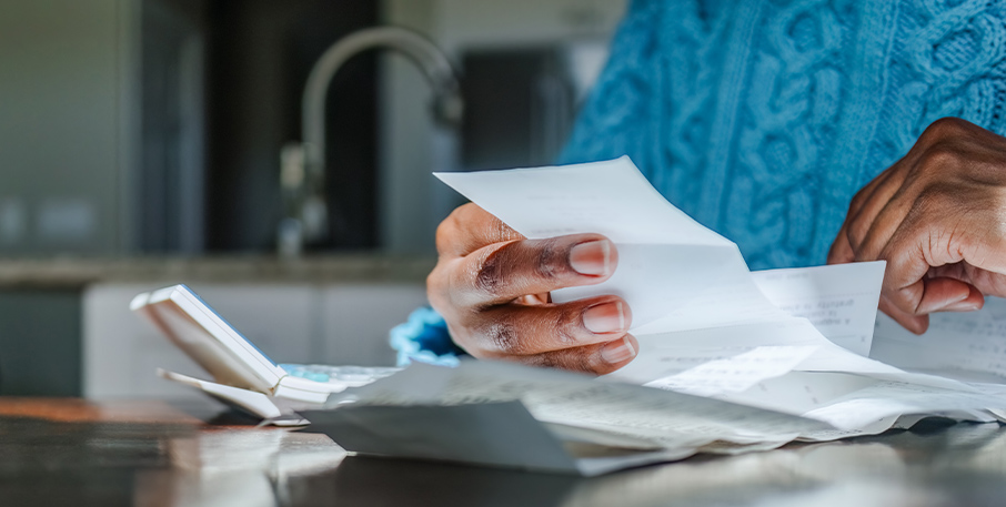 Someone holding one piece of a stack of papers