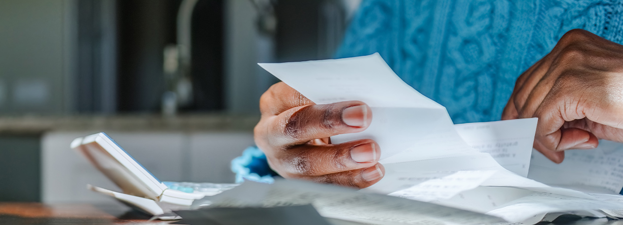 Someone holding one piece of a stack of papers