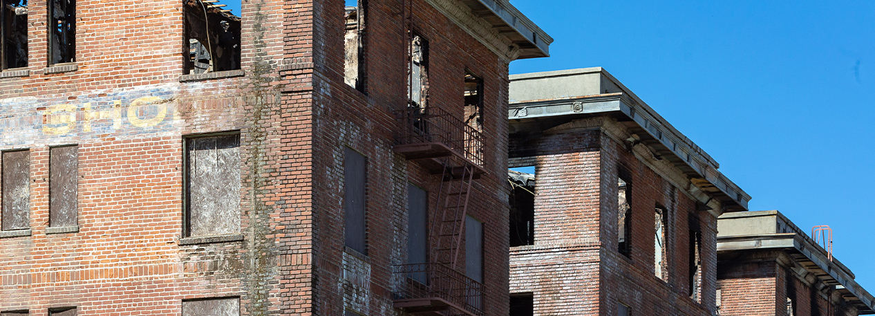 Row of buildings gutted by fire.