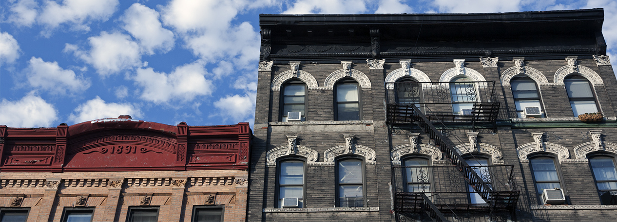 Older buildings with ornate moulding around the windows and along the roofline