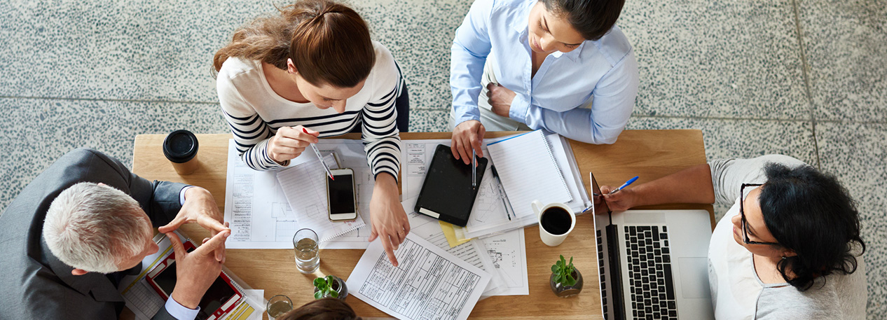 Colleagues collaborate at a table.