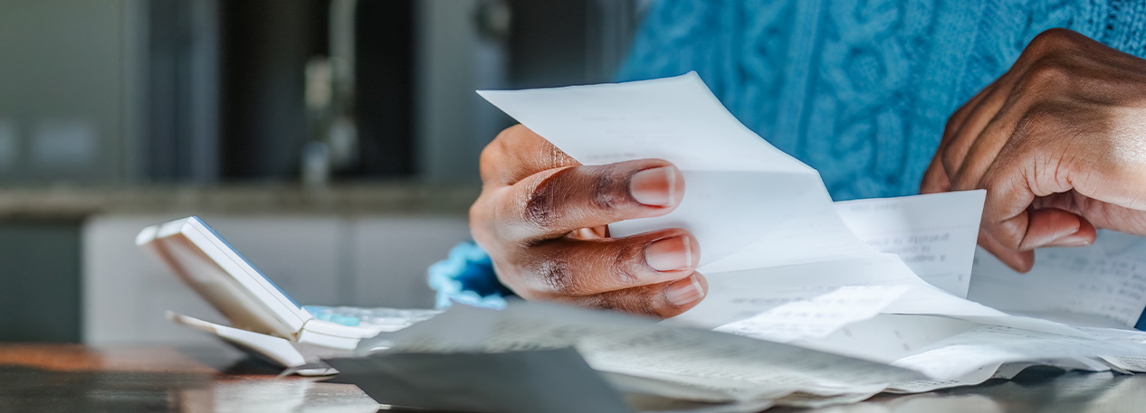 Someone at a table holding paper slip