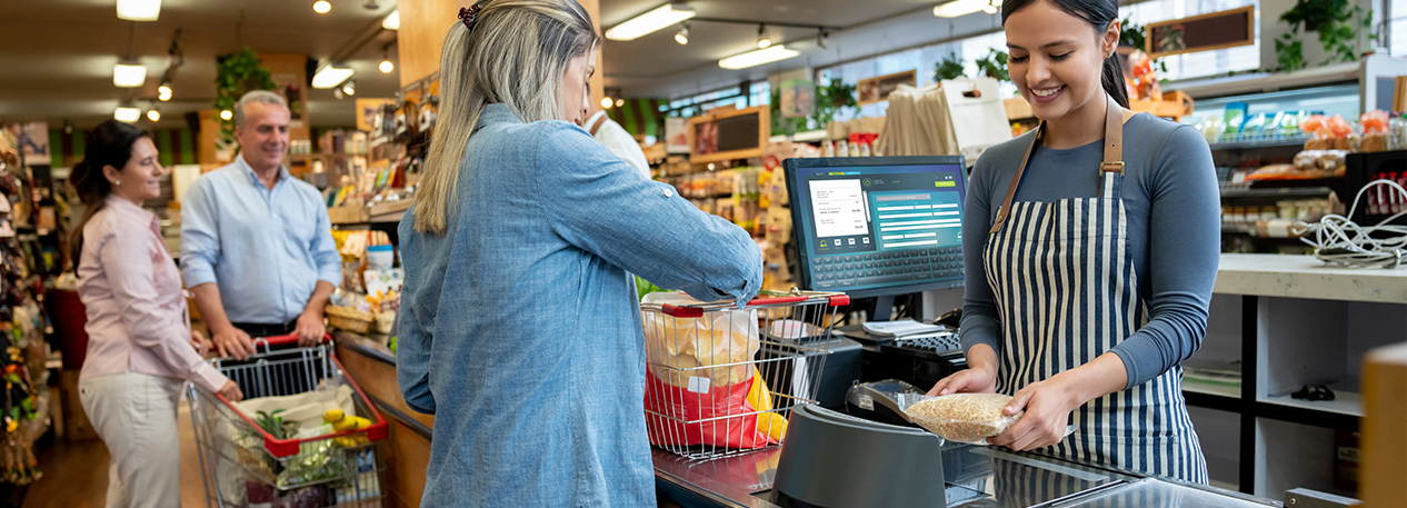 Cashier using the scanner at a grocery checkout