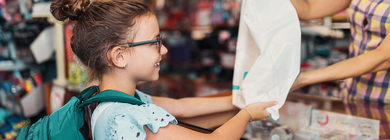 Child receiving an item from a store