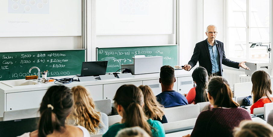 An instructor giving a lecture to students in a classroom