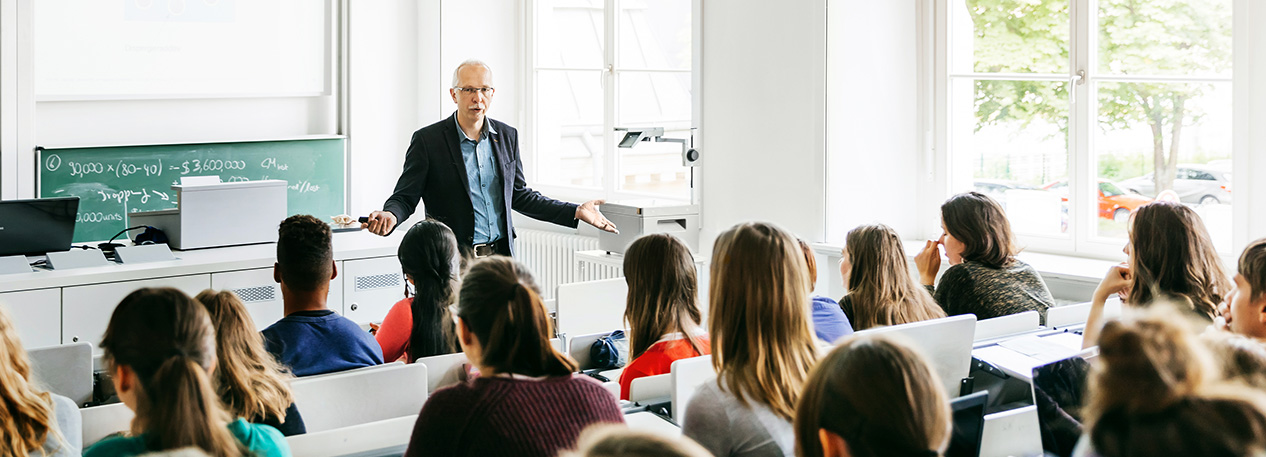 An instructor giving a lecture to students in a classroom