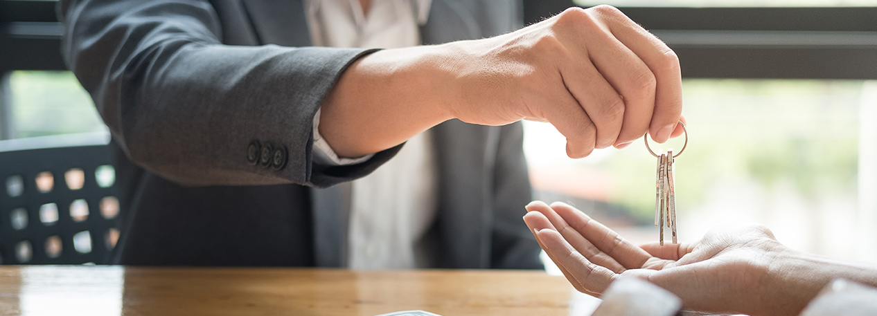 Individual handing over a set of keys