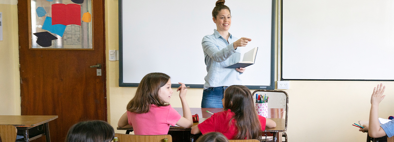 A teacher leads a classroom of children.