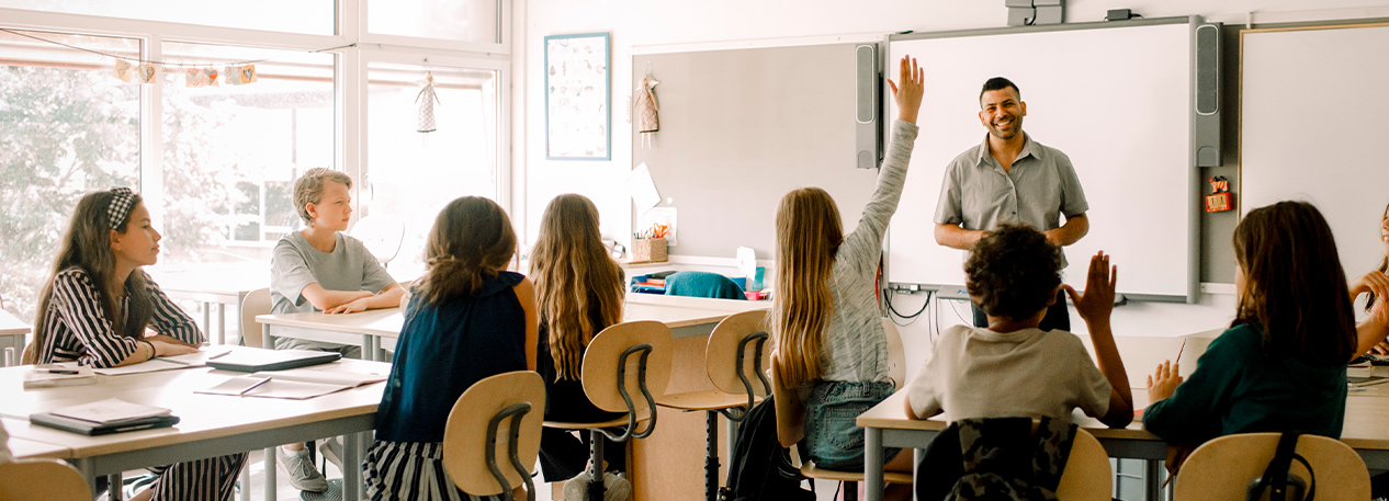 A teacher addresses a middle school classroom.