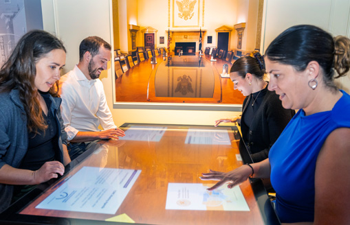 Four people playing the FOMC game in Money in Motion