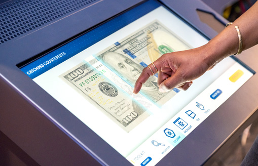 Someone playing a counterfeit currency game in Money in Motion