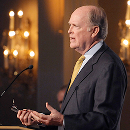 Former Philadelphia Fed President Charles Plosser addresses an audience from a podium.