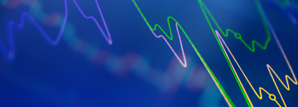 Green, yellow, and pink lines on a chart with a blue background.