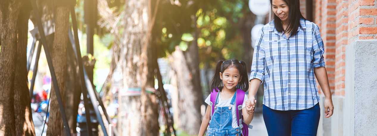 Child with backpacking walking with adult
