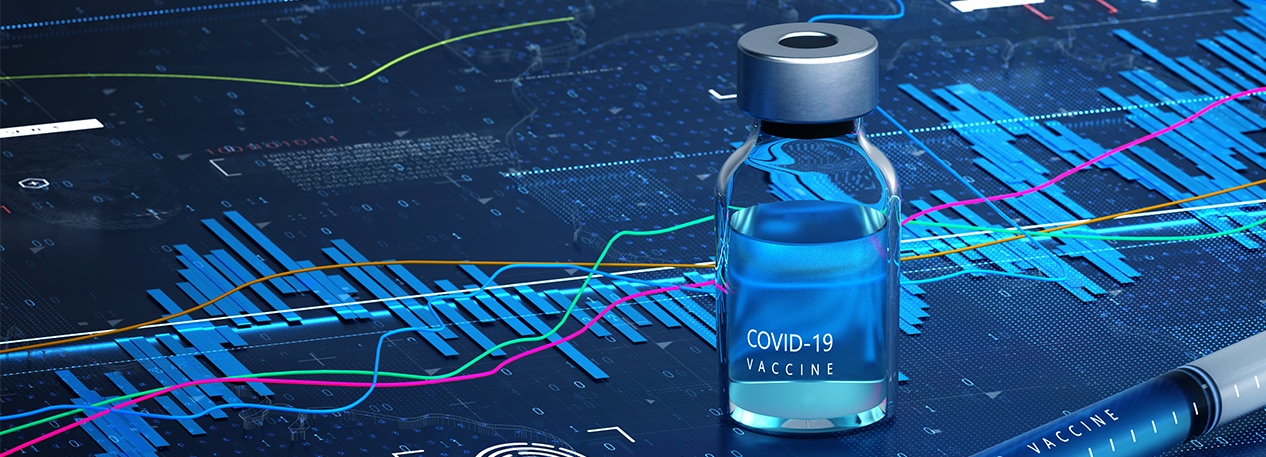 A COVID-19 vaccine vial and syringe sit on top of a complex line chart.