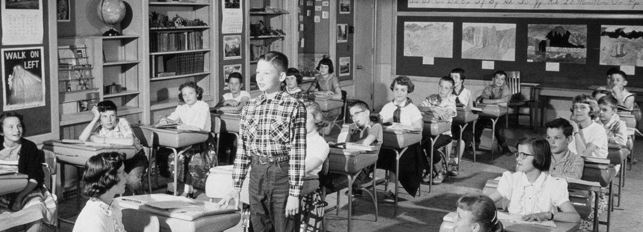 Students in a classroom rendered in black and white