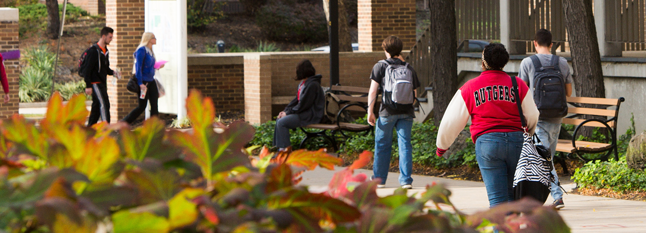 Rutgers students on campus one wearing a Rutgers jacket