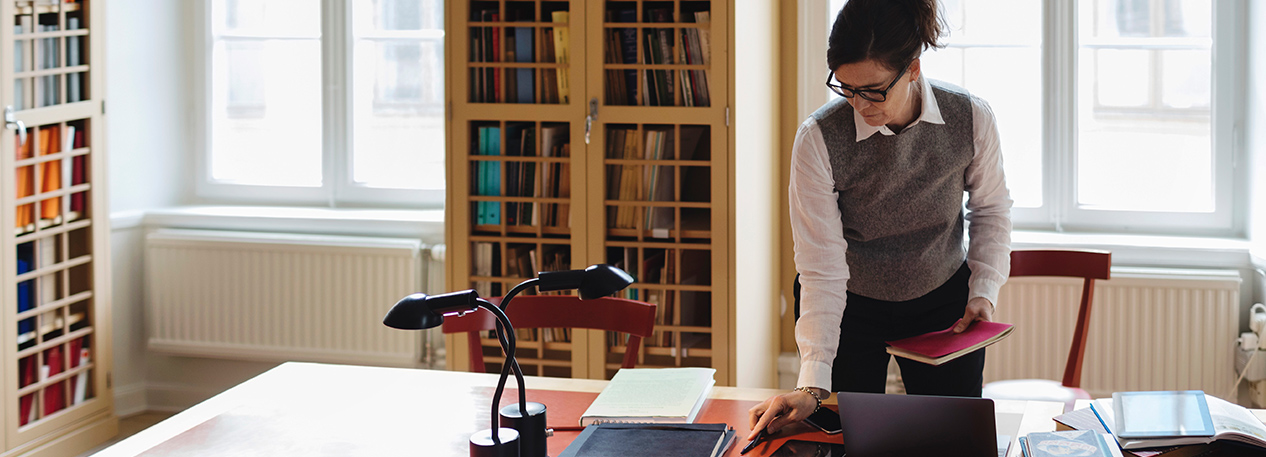 Woman browsing materials on a table