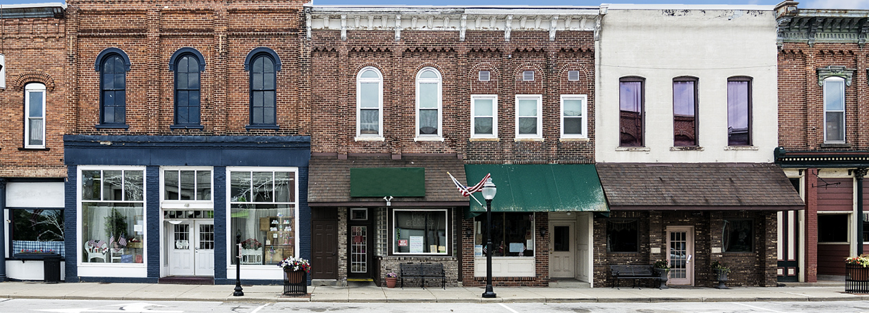 Store fronts with awnings along a small-town main street