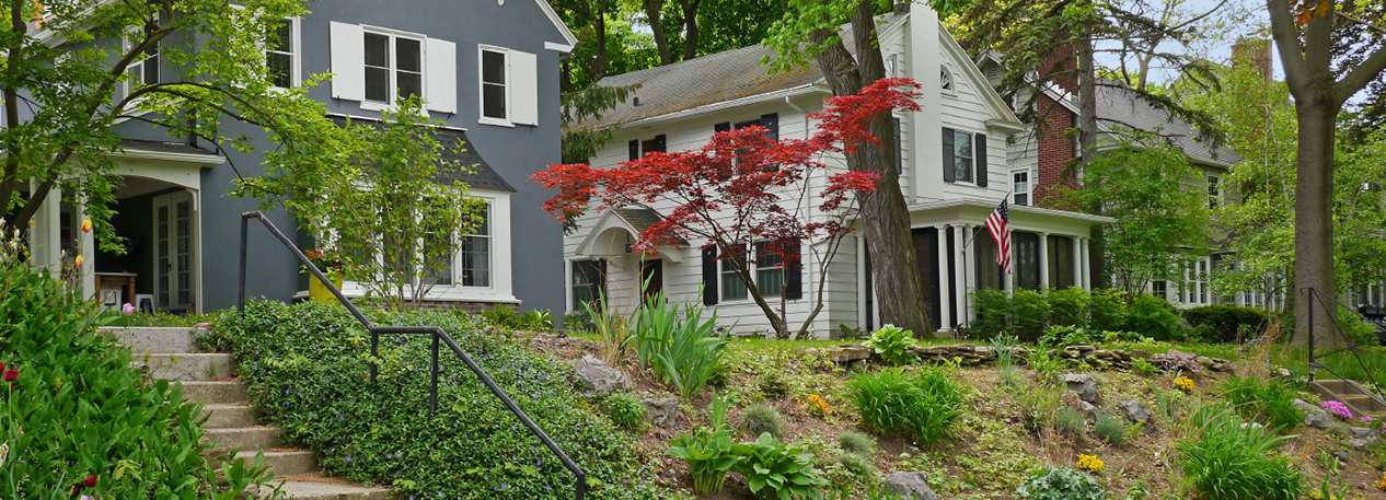 Suburban homes with steps leading up a small hill to the front porch