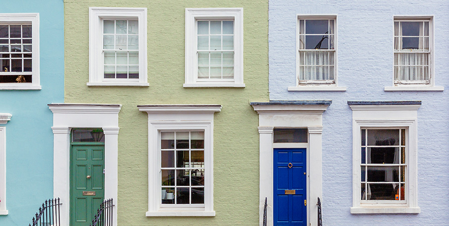 Row homes painted different shades of blue and green.