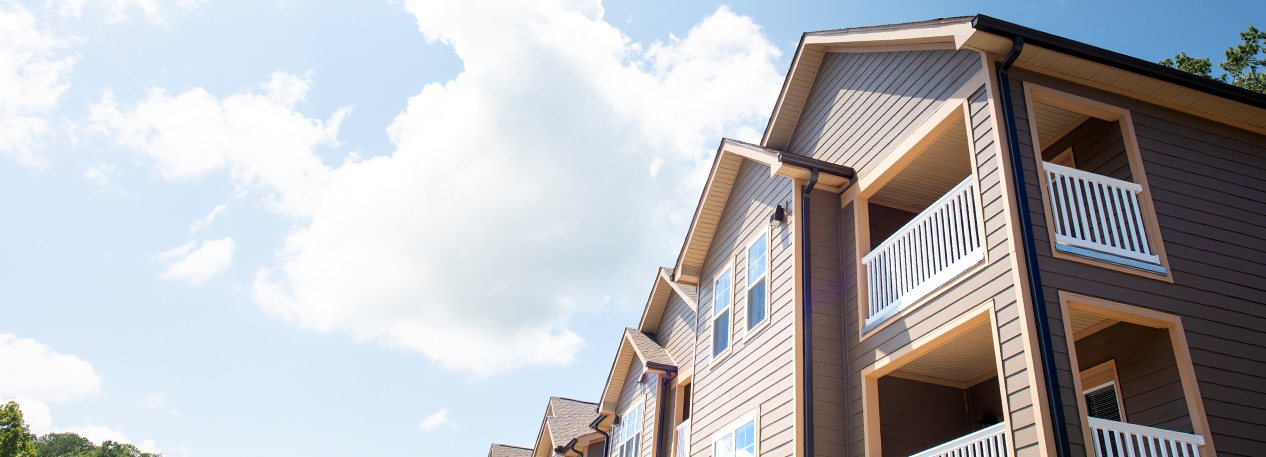 Condominiums on a partly cloudy day.