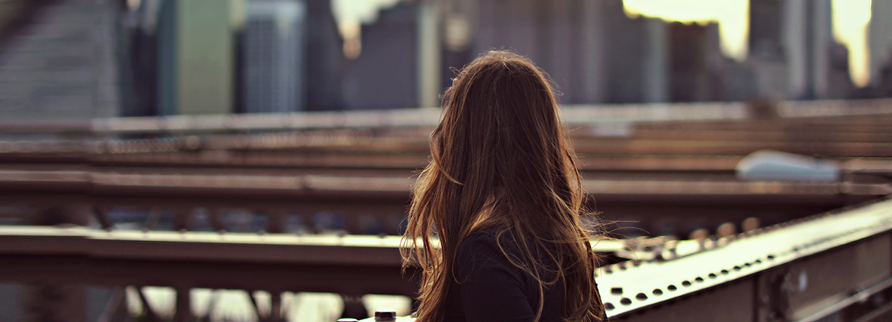 Woman looking at the city skyline in the distance