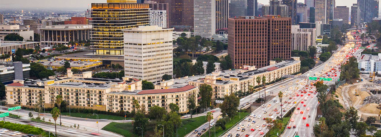 Skyline of Los Angeles with multi-lane freeways in the foreground