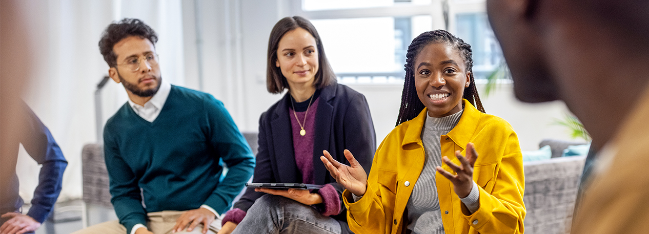 A group of young people engage in conversation.