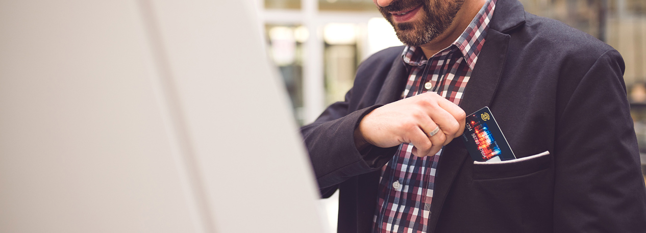 Man putting a credit card in his jacket's breast pocket