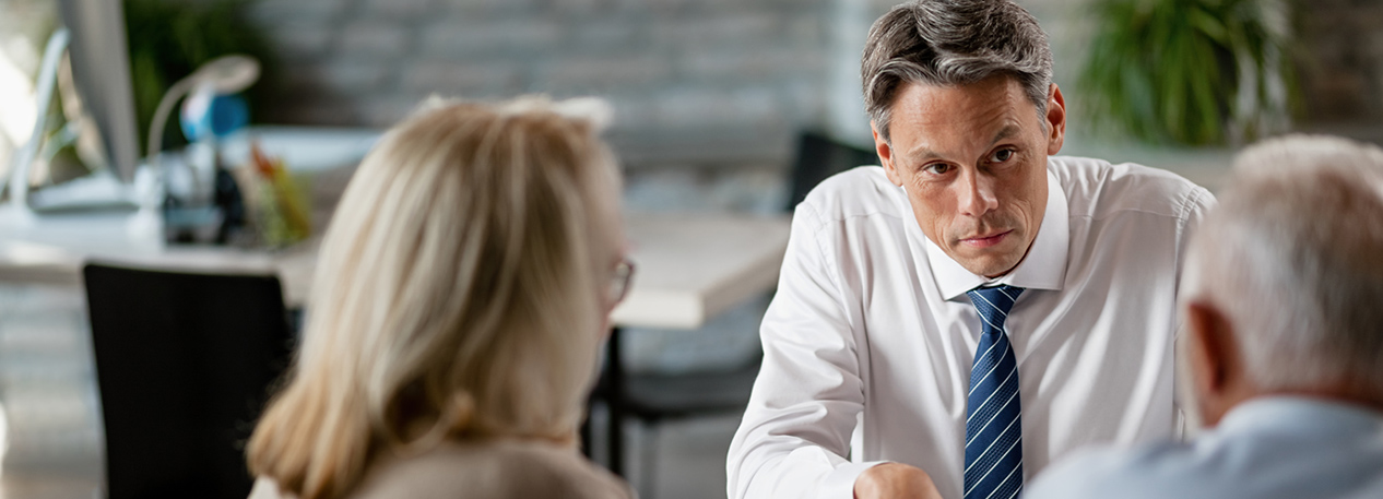 A husband a wife are in discussion with a banker.