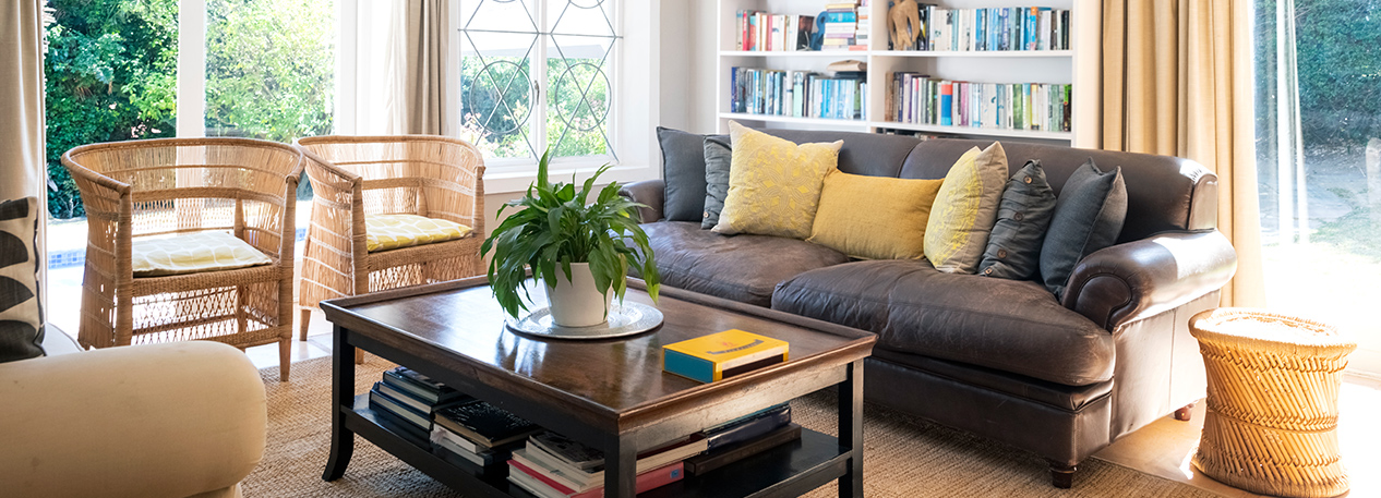 Living room with sofa, coffee table, and bookshelves