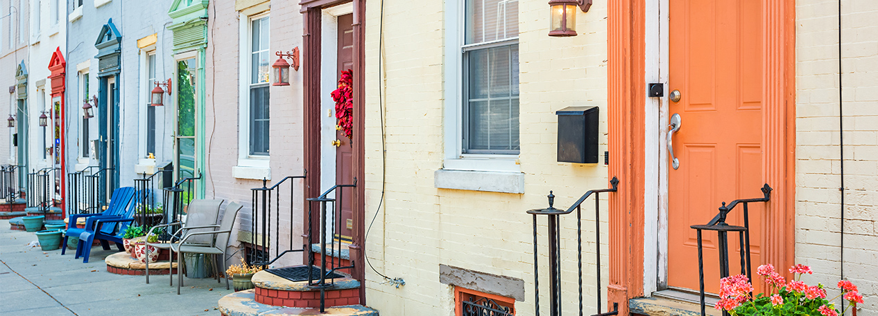 Front steps of a row of townhouses with colorful doors