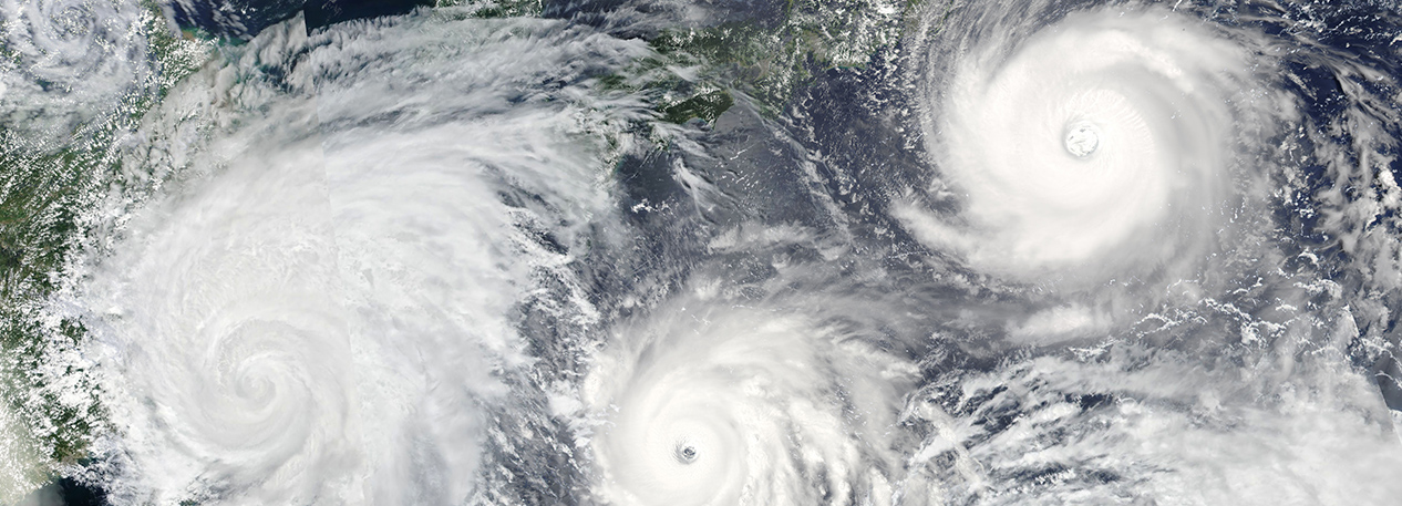 An aerial view of multiple hurricanes.