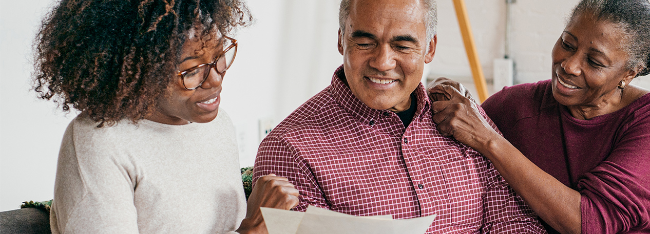 Older couple looking at documents with a younger woman