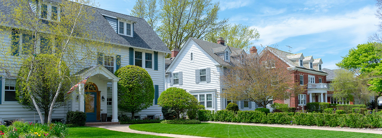 Well manicured front lawns and upscale suburban houses