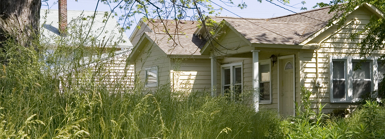 Home with overgrown lawn