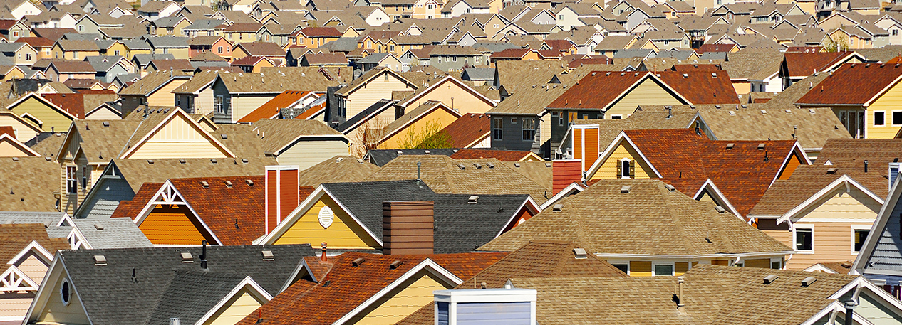 Many rooftops crowded together in a suburban development.