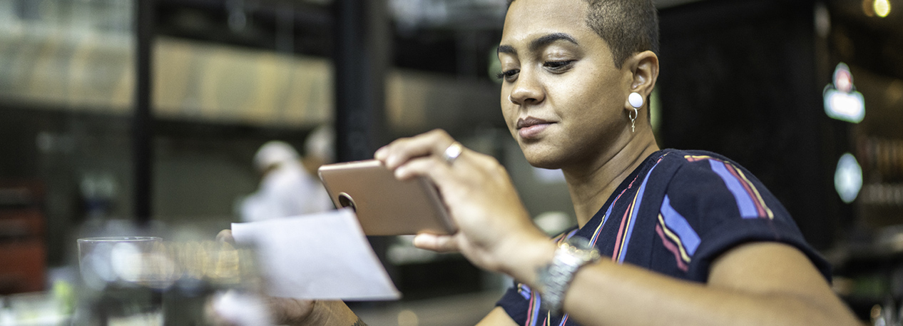 Woman depositing a check on her cell phone