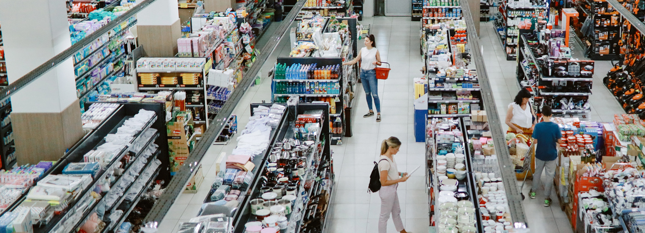 A top-down shot of shoppers browsing the aisles of a big box store.